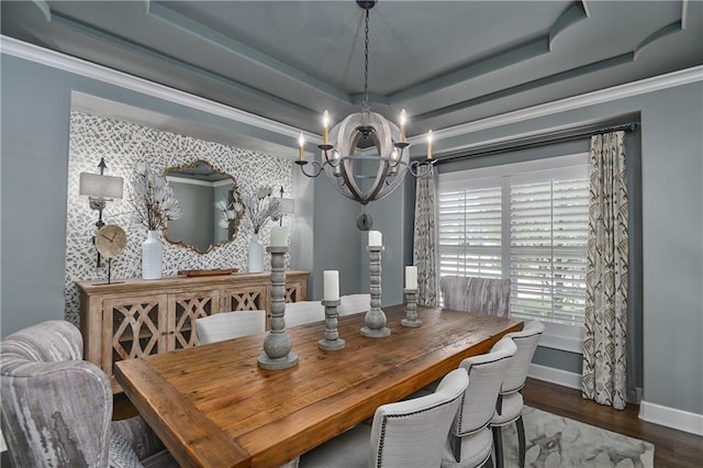 4502 Verona Ct, Riverside, MO 64150 - dining room featuring a tray ceiling, a chandelier, baseboards, wood finished floors, and crown molding