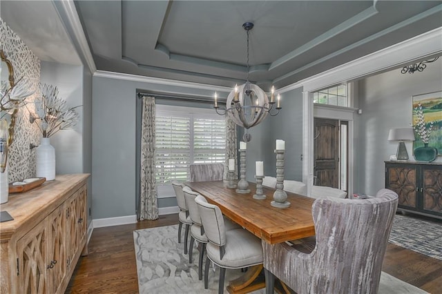 4502 Verona Ct, Riverside, MO 64150 - dining room with a chandelier, dark wood-style flooring, a tray ceiling, baseboards, and crown molding