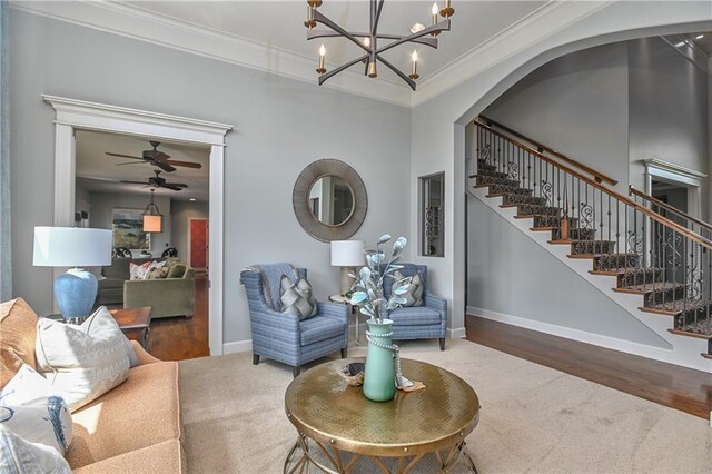 4502 Verona Ct, Riverside, MO 64150 - living area with crown molding, stairway, baseboards, a chandelier, and ceiling fan