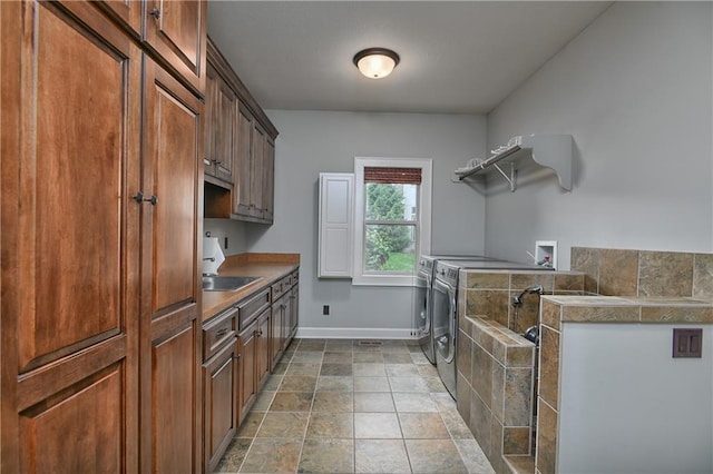 4502 Verona Ct, Riverside, MO 64150 - clothes washing area featuring cabinet space, baseboards, light stone finish floors, and washing machine and dryer