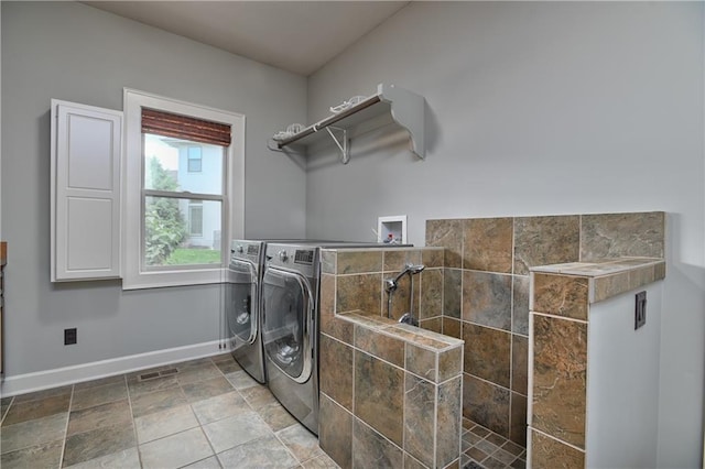 4502 Verona Ct, Riverside, MO 64150 - laundry room featuring baseboards, washer and clothes dryer, and light stone finish flooring