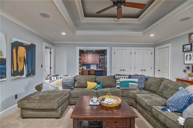 4502 Verona Ct, Riverside, MO 64150 - carpeted living room featuring ornamental molding, ceiling fan, recessed lighting, a tray ceiling, and baseboards