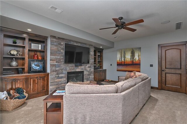 4502 Verona Ct, Riverside, MO 64150 - carpeted living room with a ceiling fan, a stone fireplace, baseboards, built in features, and recessed lighting