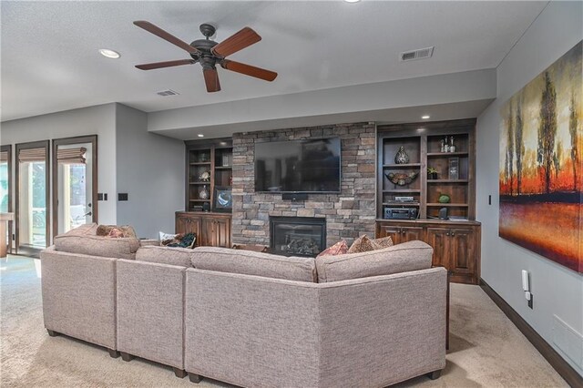 4502 Verona Ct, Riverside, MO 64150 - living area featuring light colored carpet, a ceiling fan, baseboards, built in shelves, and recessed lighting