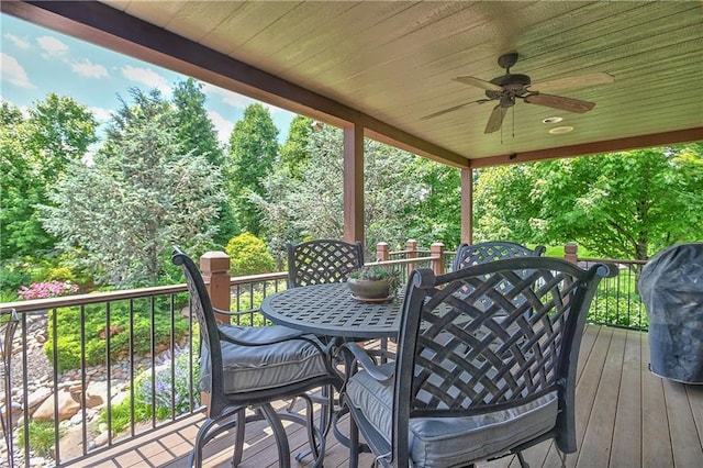 4502 Verona Ct, Riverside, MO 64150 - wooden deck with outdoor dining area, a ceiling fan, view of scattered trees, and a grill