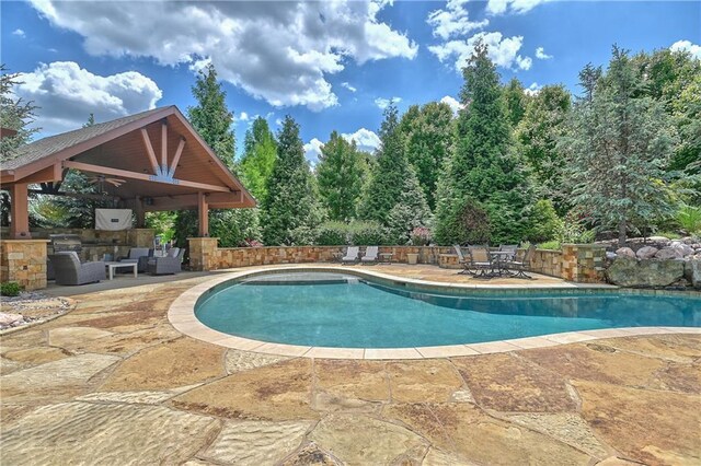 4502 Verona Ct, Riverside, MO 64150 - view of pool with a gazebo, a patio area, outdoor lounge area, and exterior kitchen