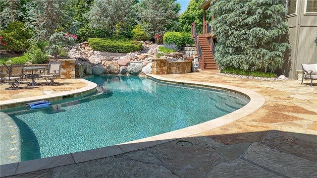 4502 Verona Ct, Riverside, MO 64150 - swimming pool with stairway and a patio area