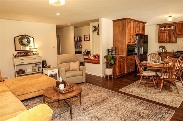 living room featuring dark wood-style floors, recessed lighting, and baseboards