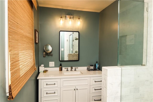 full bath featuring tiled shower, vanity, and wooden walls