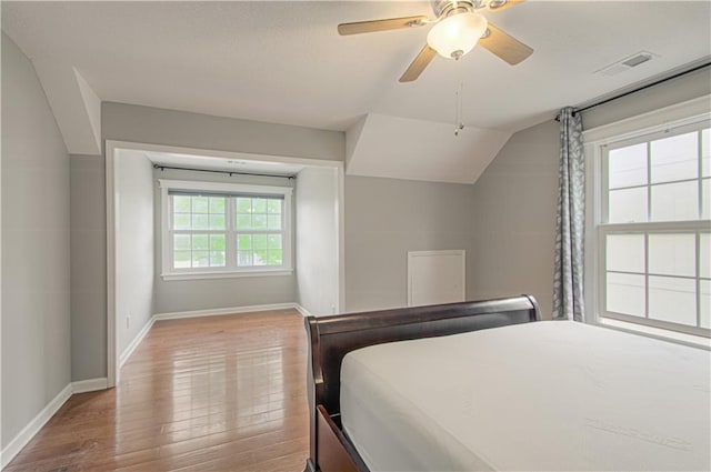 bedroom with baseboards, wood finished floors, a ceiling fan, and vaulted ceiling