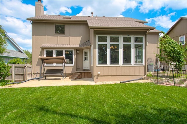 rear view of house featuring a chimney, a patio area, roof with shingles, and entry steps
