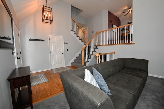 15363 S Darnell St, Olathe, KS 66062 - living room with baseboards, stairway, a ceiling fan, wood finished floors, and high vaulted ceiling