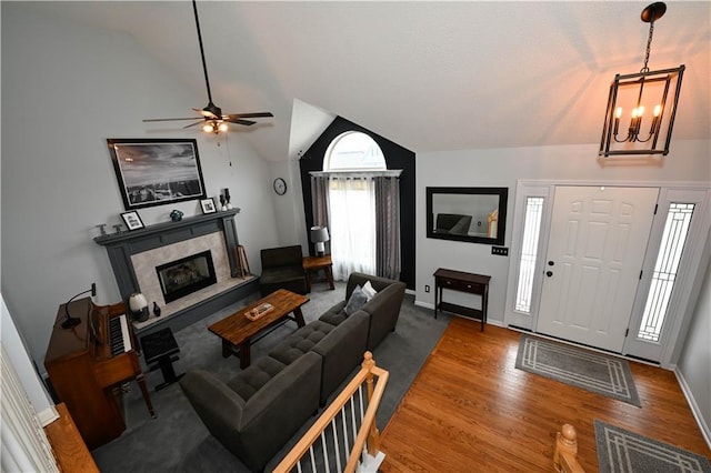 15363 S Darnell St, Olathe, KS 66062 - living area with lofted ceiling, a chandelier, wood finished floors, a ceiling fan, and a fireplace