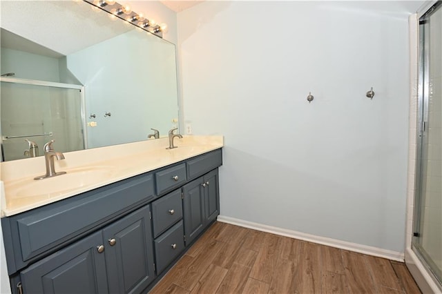 15363 S Darnell St, Olathe, KS 66062 - full bathroom featuring wood finished floors, double vanity, an enclosed shower, and baseboards