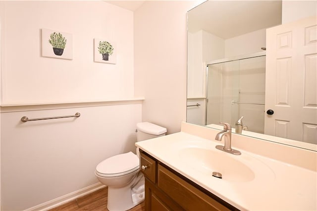 15363 S Darnell St, Olathe, KS 66062 - full bath featuring wood finished floors, vanity, an enclosed shower, toilet, and baseboards