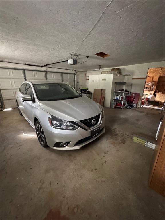 209 S 4th St, Arma, KS 66712 - garage with a garage door opener
