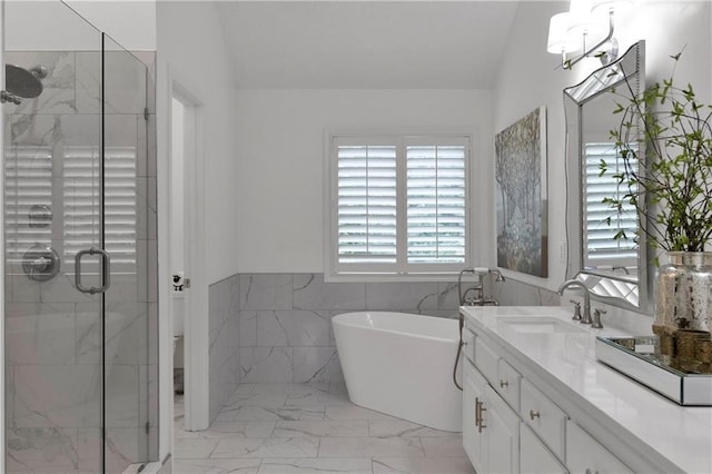 5318 W 159th Ter, Overland Park, KS 66085 - bathroom featuring marble look tile flooring, vanity, a shower stall, tile walls, and a soaking tub