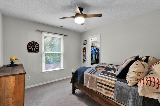 5318 W 159th Ter, Overland Park, KS 66085 - bedroom featuring carpet floors, baseboards, ceiling fan, a textured ceiling, and a walk in closet