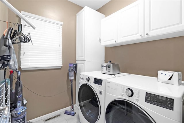 5318 W 159th Ter, Overland Park, KS 66085 - washroom featuring cabinet space, washing machine and dryer, baseboards, and tile patterned flooring