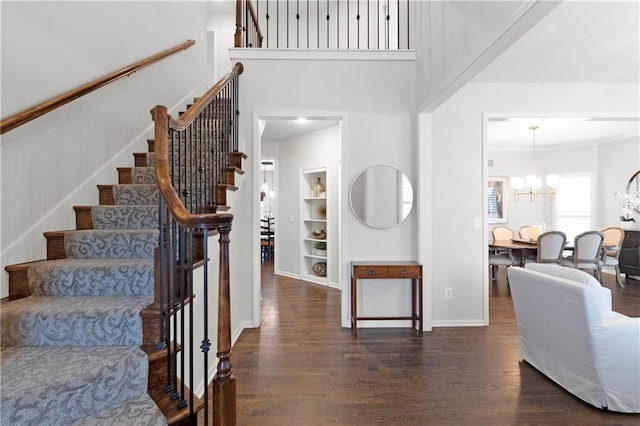 5318 W 159th Ter, Overland Park, KS 66085 - stairs featuring wood finished floors, a chandelier, built in features, baseboards, and a high ceiling