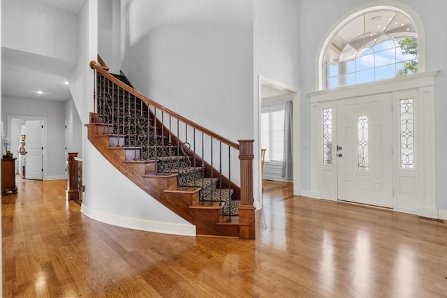 8127 Lone Elm Rd, Lenexa, KS 66220 - entrance foyer with a towering ceiling, wood finished floors, stairs, baseboards, and recessed lighting