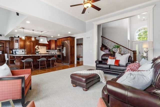 8127 Lone Elm Rd, Lenexa, KS 66220 - carpeted living area featuring a ceiling fan, stairs, crown molding, and recessed lighting