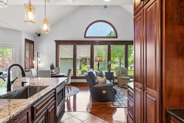 8127 Lone Elm Rd, Lenexa, KS 66220 - kitchen with a sink, high vaulted ceiling, healthy amount of natural light, and light stone countertops