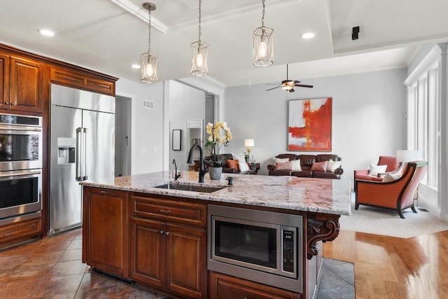 8127 Lone Elm Rd, Lenexa, KS 66220 - kitchen with stainless steel appliances, a sink, decorative light fixtures, light stone countertops, and ornamental molding