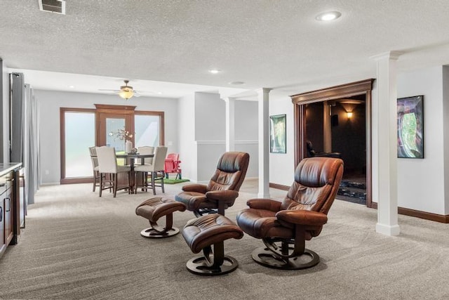 8127 Lone Elm Rd, Lenexa, KS 66220 - living area featuring light colored carpet, a textured ceiling, baseboards, decorative columns, and a ceiling fan