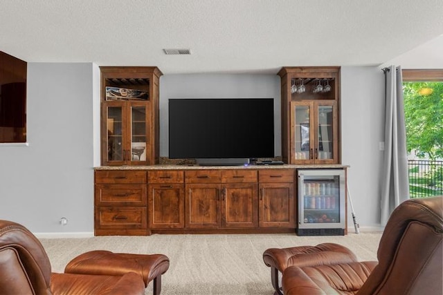 8127 Lone Elm Rd, Lenexa, KS 66220 - living area featuring beverage cooler, light carpet, baseboards, and a bar