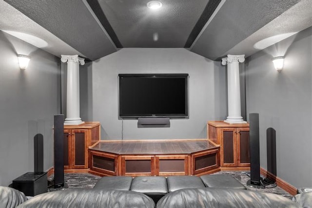 8127 Lone Elm Rd, Lenexa, KS 66220 - cinema with ornate columns, vaulted ceiling, baseboards, and a textured ceiling