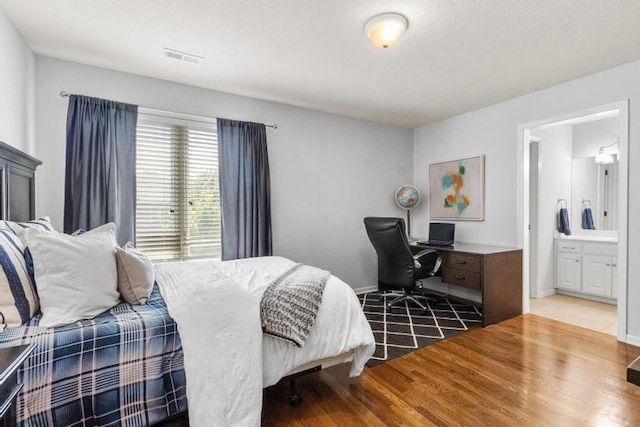8127 Lone Elm Rd, Lenexa, KS 66220 - bedroom with wood finished floors, ensuite bath, and baseboards