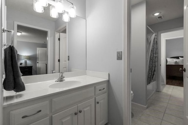 8127 Lone Elm Rd, Lenexa, KS 66220 - bathroom featuring vanity, tile patterned floors, shower / tub combo with curtain, and toilet