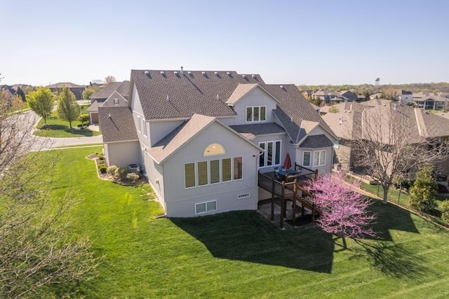 8127 Lone Elm Rd, Lenexa, KS 66220 - back of property featuring a lawn, a residential view, and a shingled roof