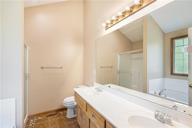 bathroom with toilet, a stall shower, a textured ceiling, double vanity, and baseboards