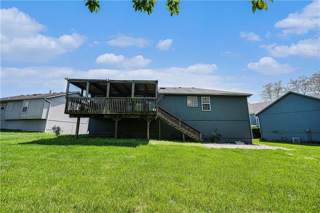 back of house with a wooden deck, stairway, and a lawn