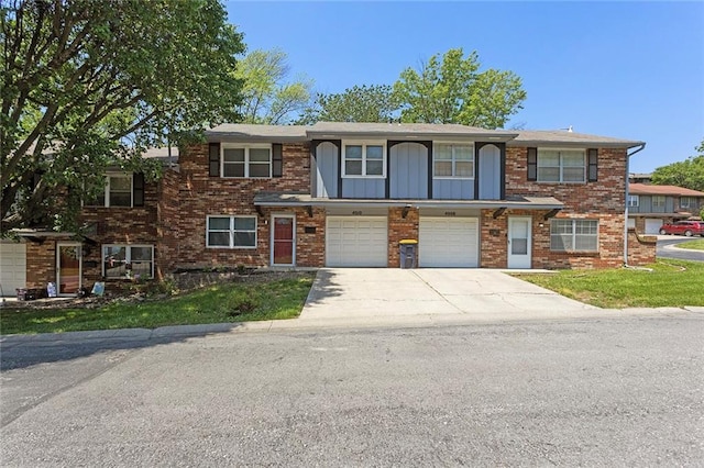 4010 Hedges Ave, Kansas City, MO 64133 - view of property featuring driveway, an attached garage, and brick siding