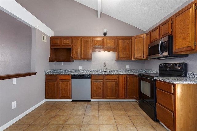 4010 Hedges Ave, Kansas City, MO 64133 - kitchen with appliances with stainless steel finishes, brown cabinets, light stone counters, a sink, and light tile patterned floors
