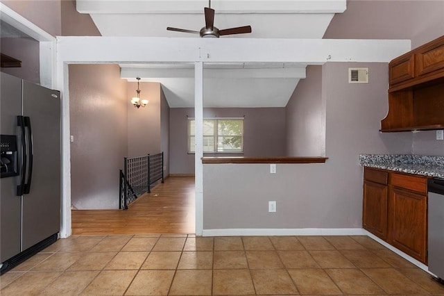 4010 Hedges Ave, Kansas City, MO 64133 - kitchen featuring stainless steel appliances, ceiling fan, light tile patterned floors, brown cabinetry, and baseboards