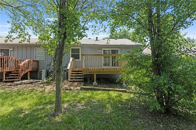 4010 Hedges Ave, Kansas City, MO 64133 - back of house featuring a deck, stairway, and central air condition unit