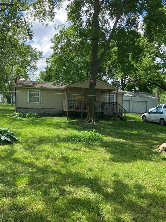 206 W 5th St, Pleasanton, KS 66075 - view of green lawn featuring a garage