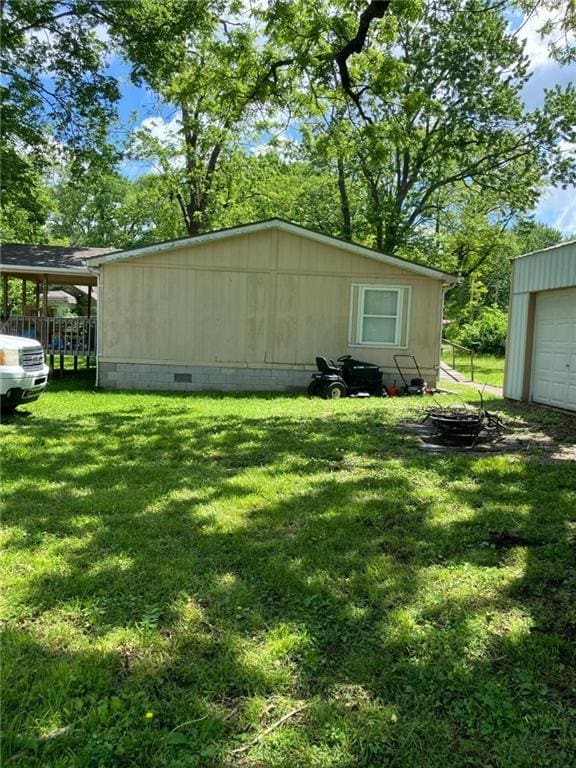 206 W 5th St, Pleasanton, KS 66075 - view of property exterior with a lawn and crawl space