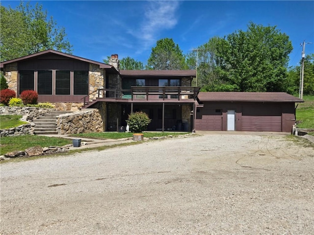 33295 Bethel Church Rd, Osawatomie, KS 66064 - view of front of property with stone siding, stairs, a chimney, driveway, and an attached garage
