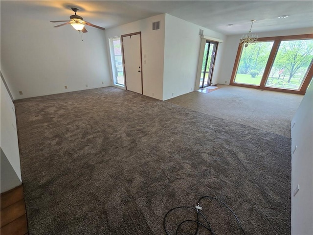 33295 Bethel Church Rd, Osawatomie, KS 66064 - unfurnished living room featuring carpet flooring, a chandelier, and ceiling fan