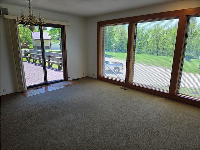 33295 Bethel Church Rd, Osawatomie, KS 66064 - carpeted empty room featuring a chandelier