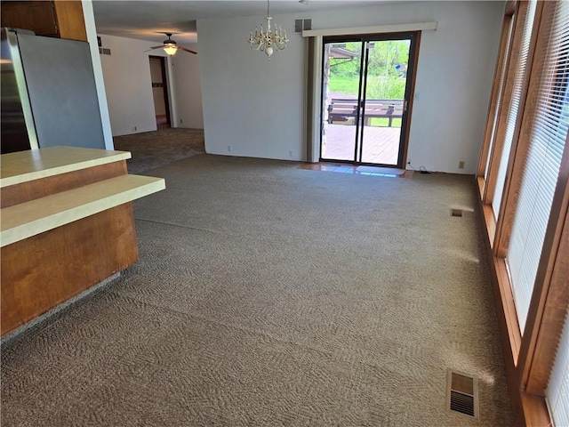 33295 Bethel Church Rd, Osawatomie, KS 66064 - unfurnished living room with carpet flooring, a chandelier, and ceiling fan