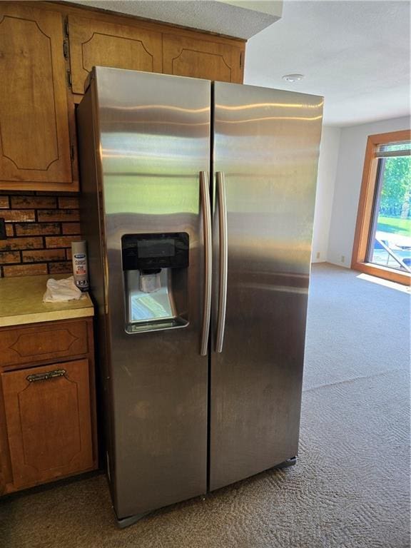 33295 Bethel Church Rd, Osawatomie, KS 66064 - kitchen featuring stainless steel fridge, carpet, brown cabinets, and light countertops