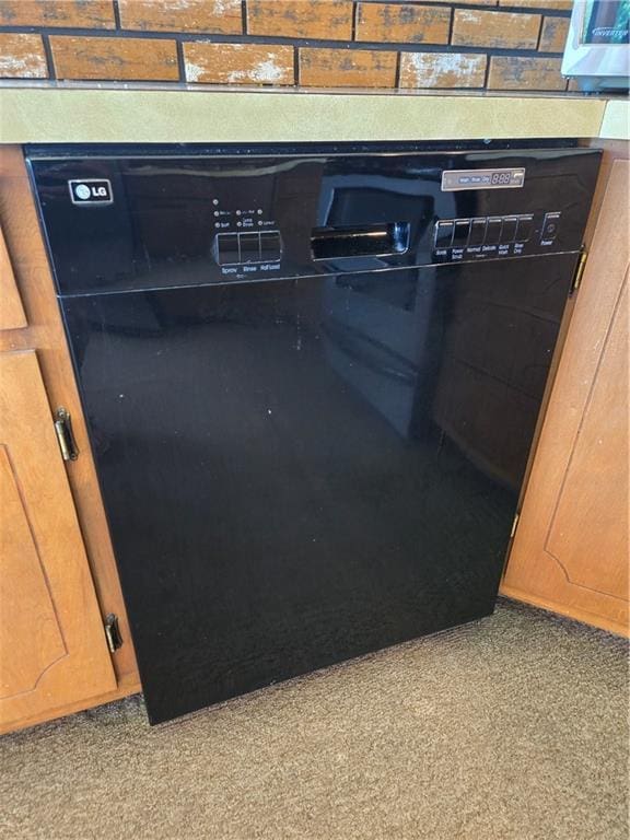 33295 Bethel Church Rd, Osawatomie, KS 66064 - kitchen view of black dishwasher and light colored carpet