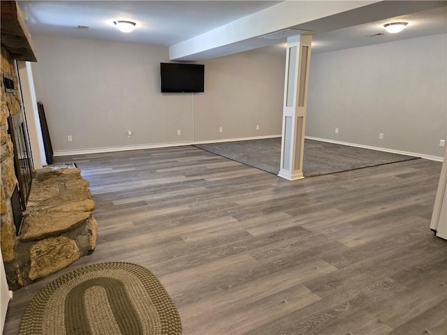 33295 Bethel Church Rd, Osawatomie, KS 66064 - finished basement featuring a stone fireplace, wood finished floors, and baseboards