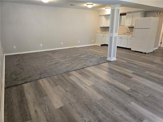 33295 Bethel Church Rd, Osawatomie, KS 66064 - unfurnished living room with a sink, dark wood-style flooring, and baseboards